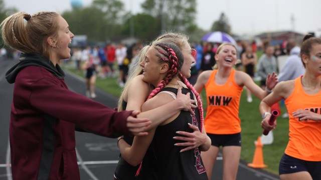  Grundy Center freshman Grace Storjohann embraces junior Ellery Luhring as junior Carlie Willis comes to celebrate their distance medley qualifying for State last week in Dike. 
